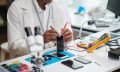 Repairman Checking Smartphone Battery