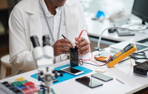 Repairman Checking Smartphone Battery